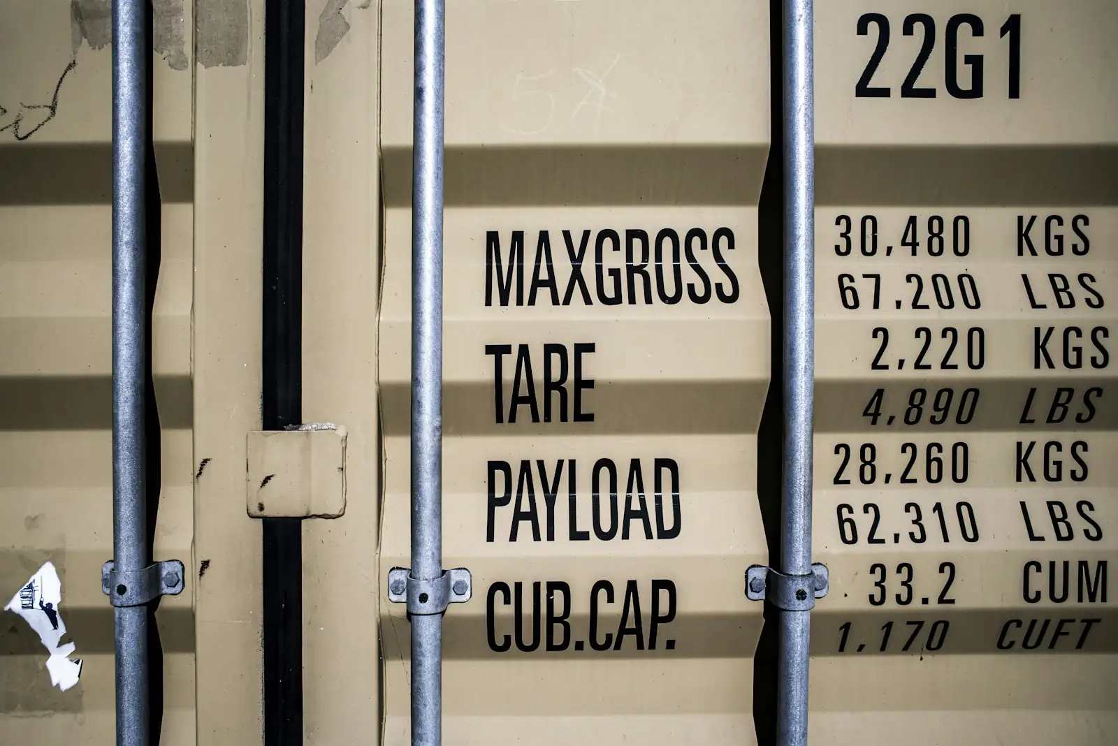 A container door data plate listing max gross, tare, payload and cubic capacity.